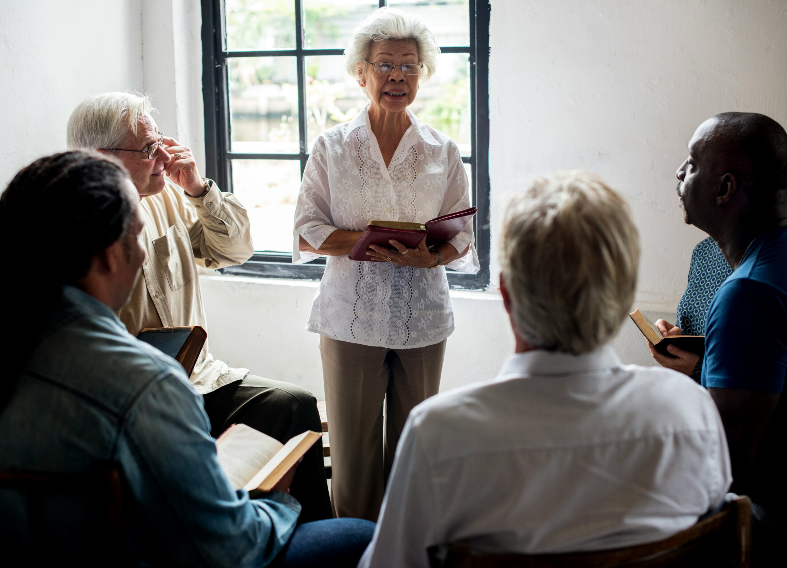 Asian woman leading meeting